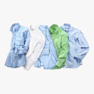 Mehrere BDO-Shirts in verschiedenen Farben auf einem Tisch.