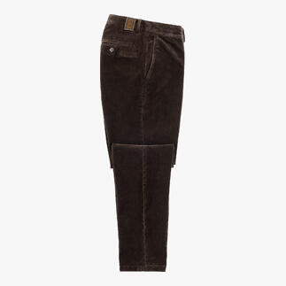 Dunkelbraune Samt-Hose, auf einem Tisch liegend mit geöffneter Tasche.