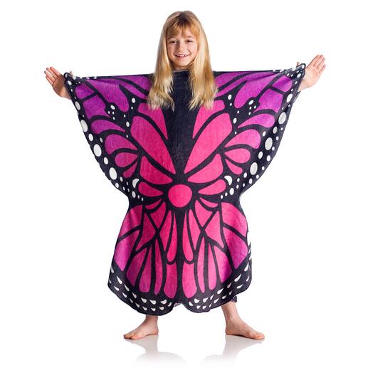 Mädchen in Poncho mit Schmetterlingsmotiv in pink und schwarz auf hellem Hintergrund.