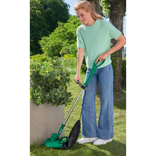 Frau mit Akku-Rasentrimmer in einem Garten