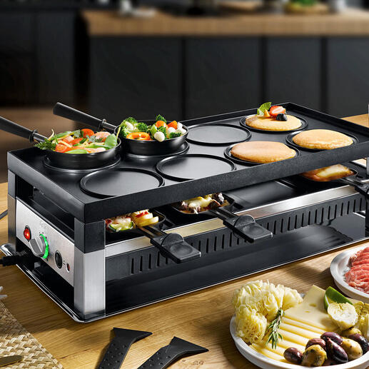 Solis Raclette- und Fun-Cooking 5-in-1 Gerät mit Gemüse und Fleisch auf dem Tisch.