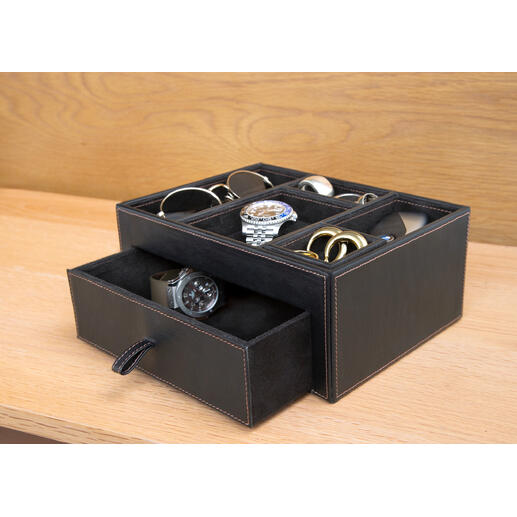 Schwarze Lederablage mit verschiedenen Accessoires wie Uhren und Brillen.