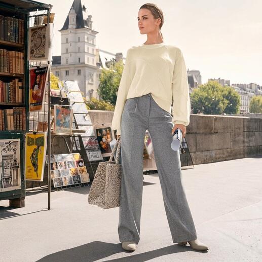 Frau trägt Junghans Basket-Pullover mit grauem Hosen und Stofftasche.