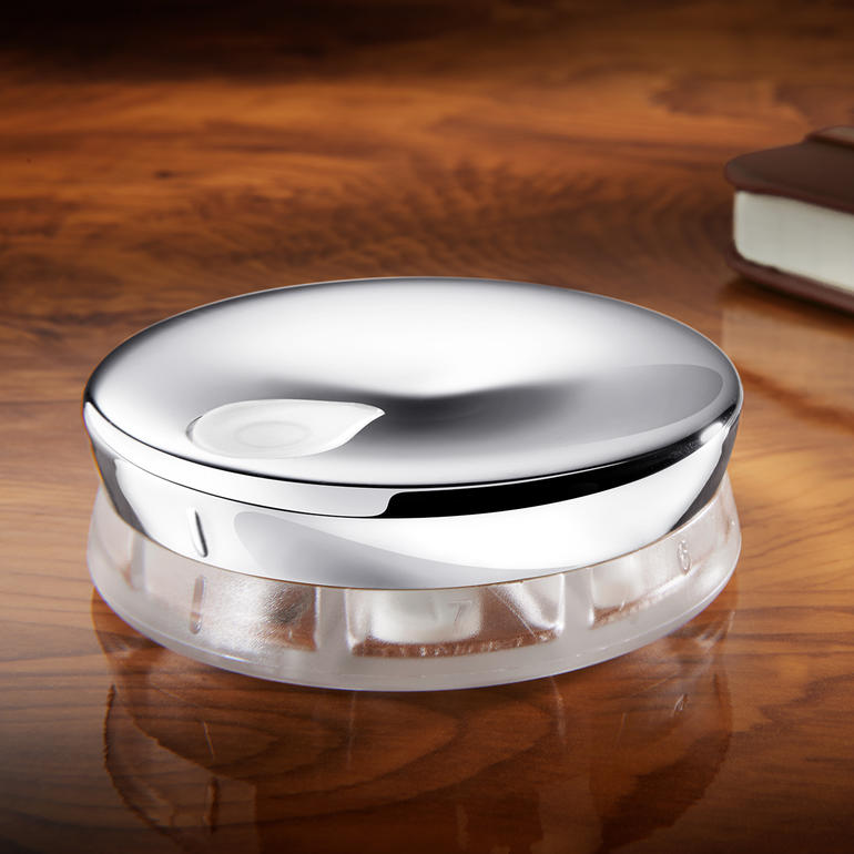 Alessi Designer Pillendose aus transparentem Material mit glänzendem Deckel.