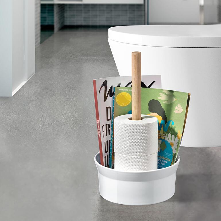 WC-Butler mit Toilettenpapier und Zeitschriften in modernem Badezimmer.