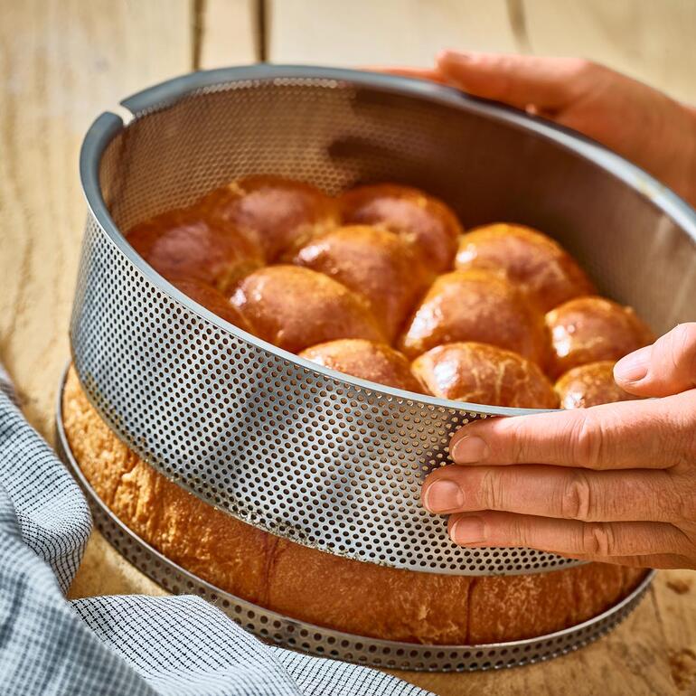 Perforierte Edelstahl-Backform mit frisch gebackenem Brot.