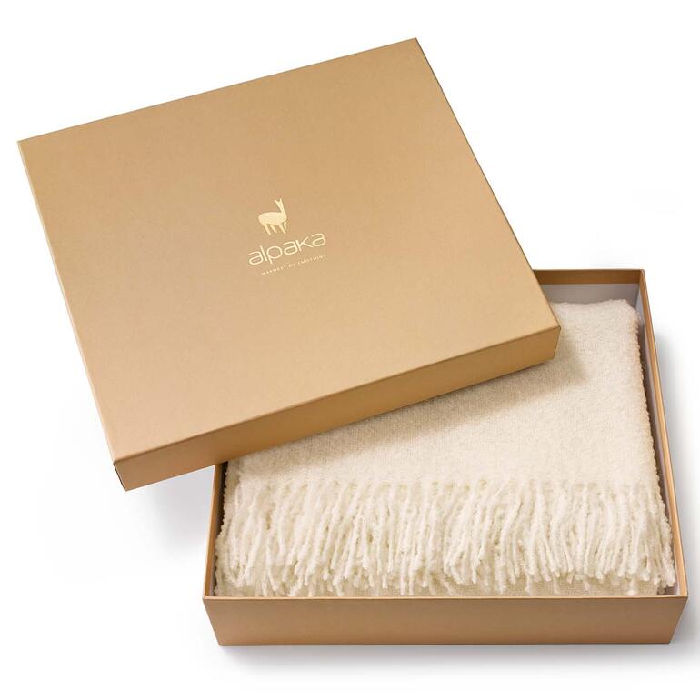 Lieferung in wertiger Geschenkbox. Alpaka-Bouclédecke in einer Geschenkbox.