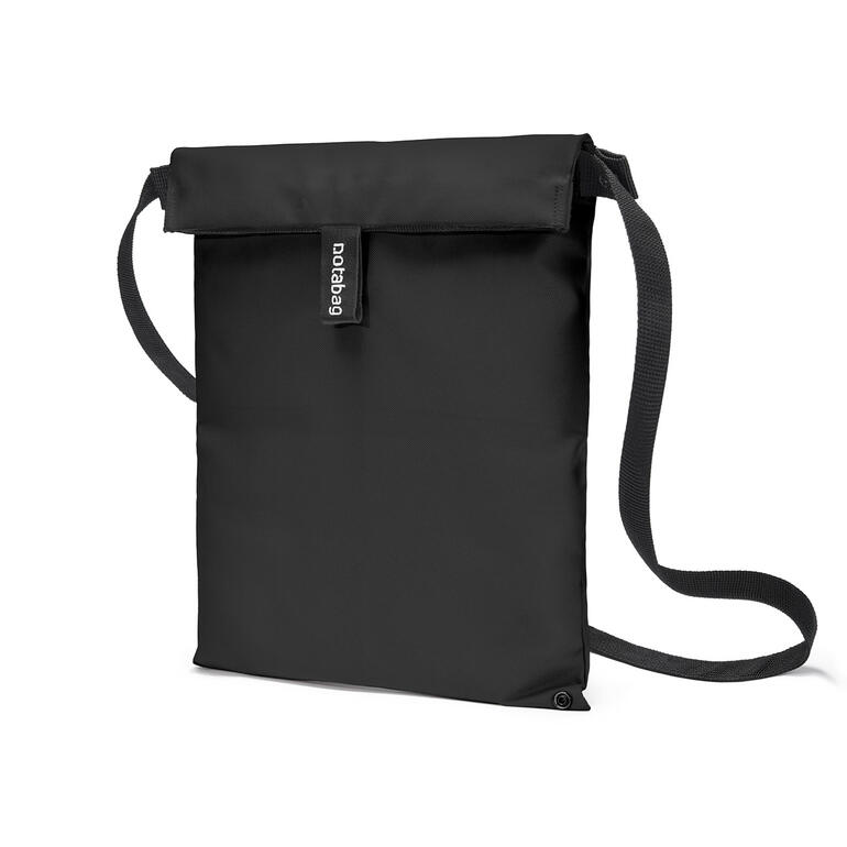 Schwarz Notabag Crossbody in Schwarz, zusammengefaltet mit Schultergurt.