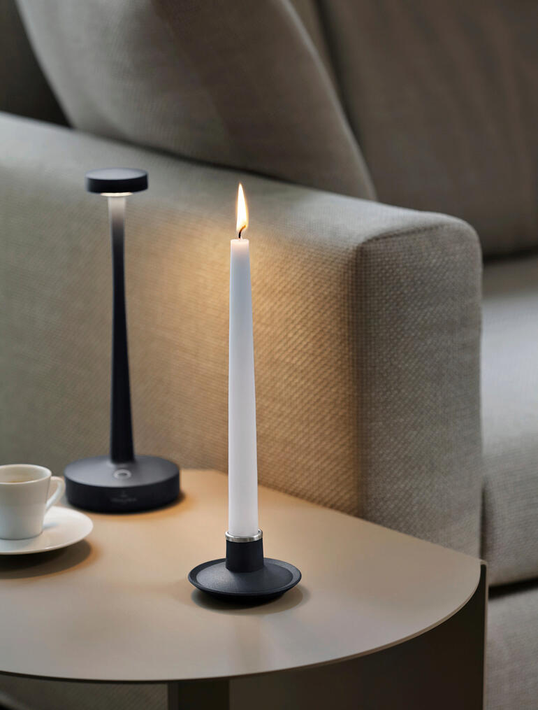 Anthrazitfarbene 2-in-1 Tischleuchte auf einem Tisch