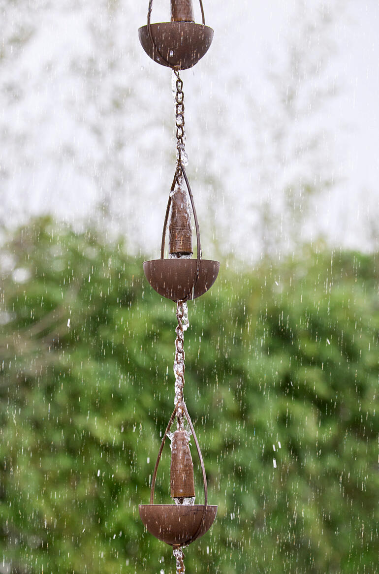 Detailansicht einer 3-in-1-Regenkette mit Wasser, das von den Bechern fließt.