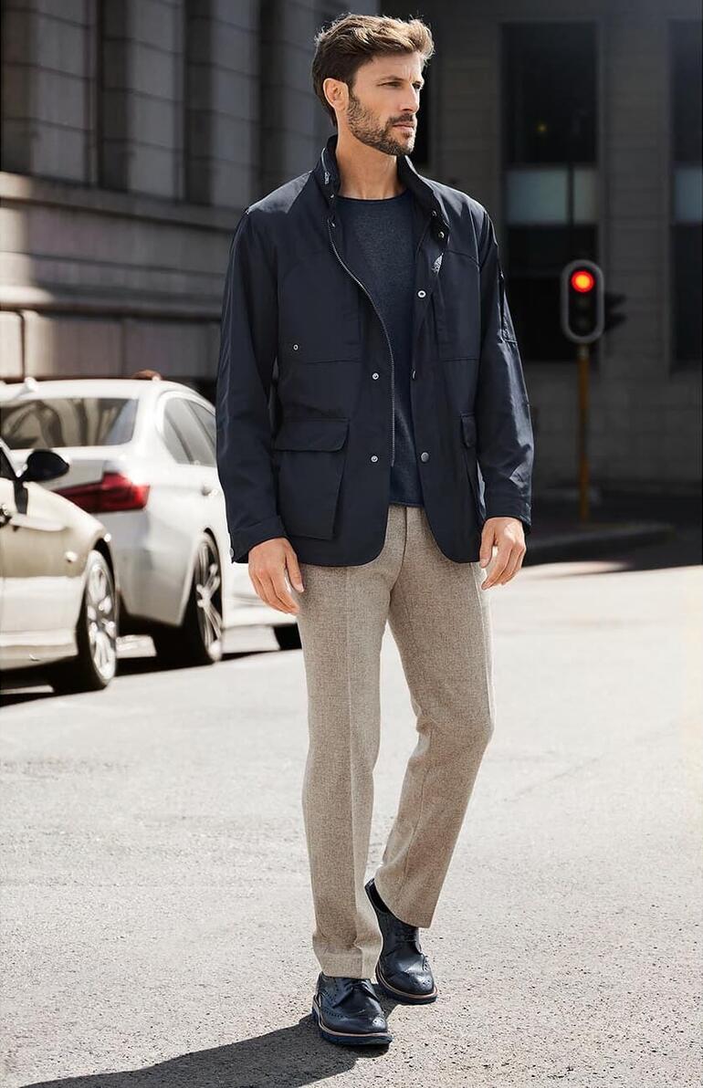 Beige Mann in smarter Casual-Funktionsjacke in der Stadt.