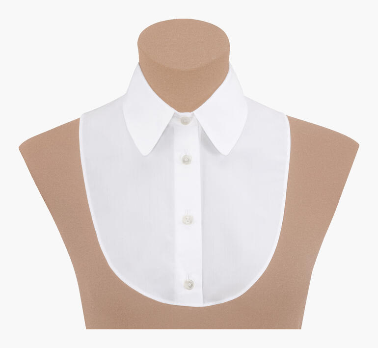 Weißer Blusenkragen auf einem beigen Modell mit Knöpfen vorne.