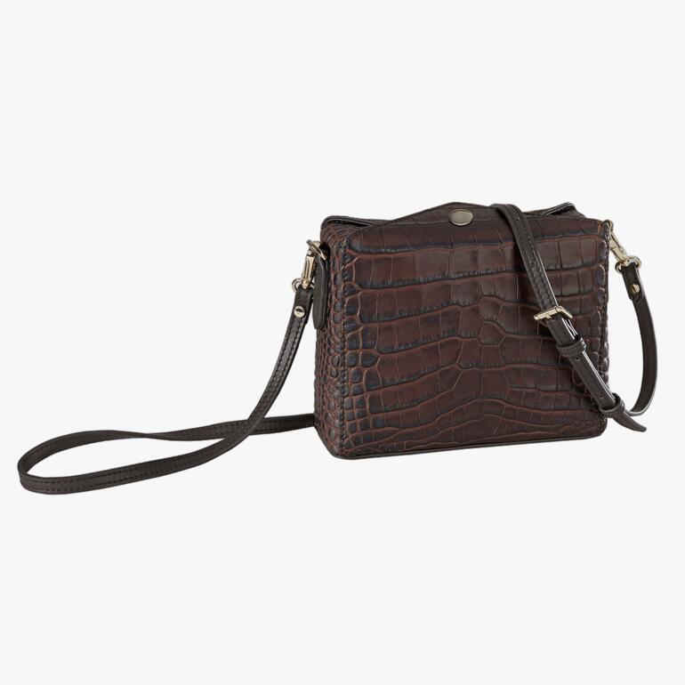 Braunes Krokodil-Leder-Boxy-Bag, auf einer weißen Fläche.