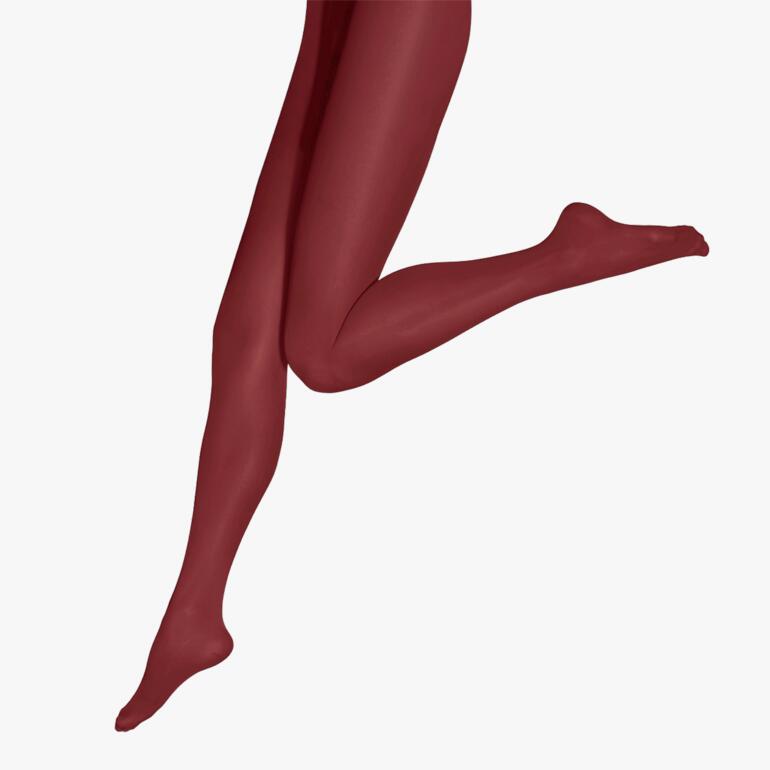Rote Oroblù Color-Tights, ein Bein in Bewegung.