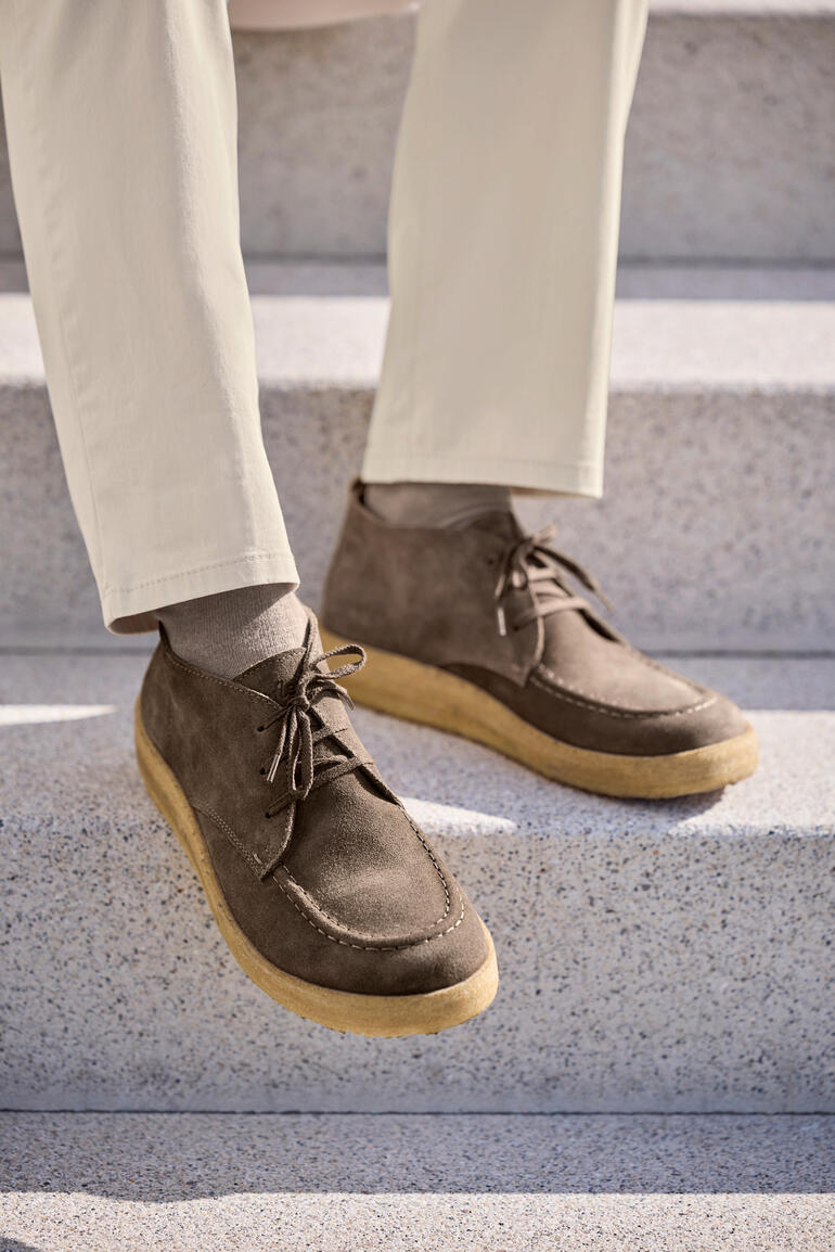 Zwei braune Chukka-Boots auf einer Treppe