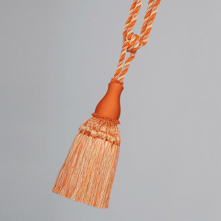Orange/Creme Raffhalter in Orange und Creme mit dekorativen Verzierungen.