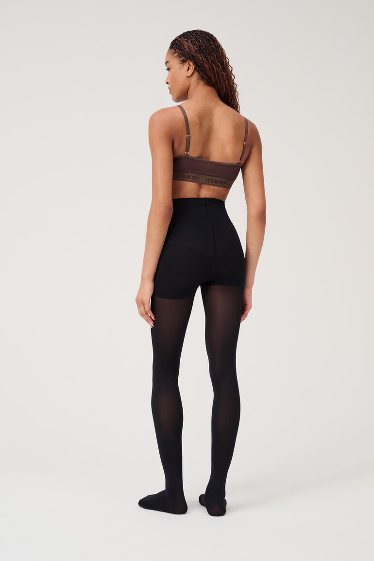 Rückansicht eines Modells in einer schwarzen Beauty-Strumpfhose.