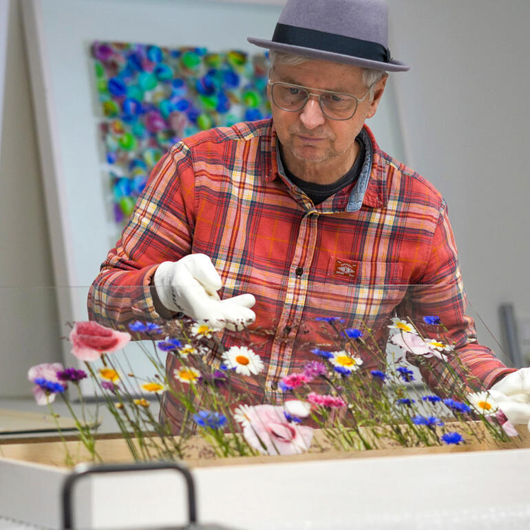 Andreas Lutherer Andreas Lutherer arrangiert Blumen in einer Kiste.